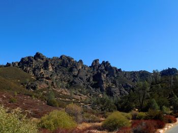 Scenic view of mountains against clear blue sky