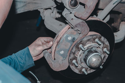 Cropped hand of man repairing car