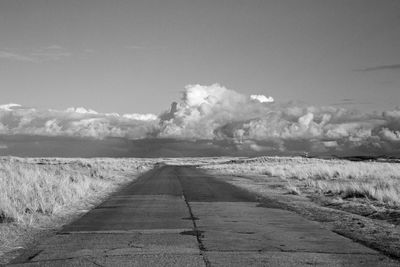 Empty road along countryside landscape