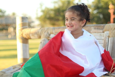 Smiling girl with omani flag