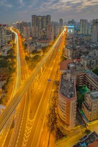 High angle view of city lit up at night