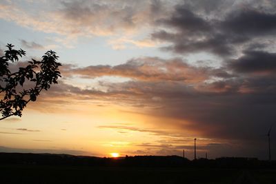 Scenic view of silhouette field against sky during sunset