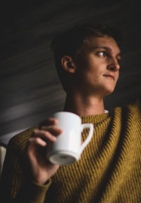 Close-up of young man drinking coffee