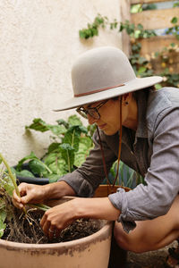 Midsection of man working on plant