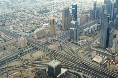 Aerial view of road intersection and modern buildings in city