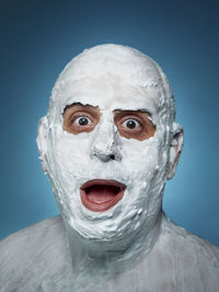 Close-up of human eye against blue background