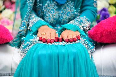 Close-up of woman sitting against blurred background