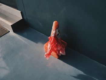 High angle view of person hand on red wall