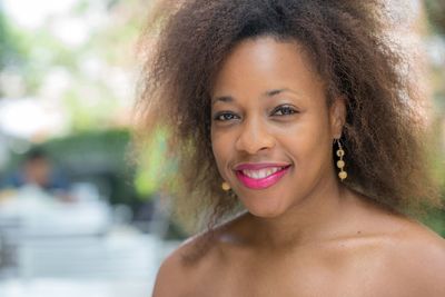 Portrait of smiling woman with frizzy hairstyle