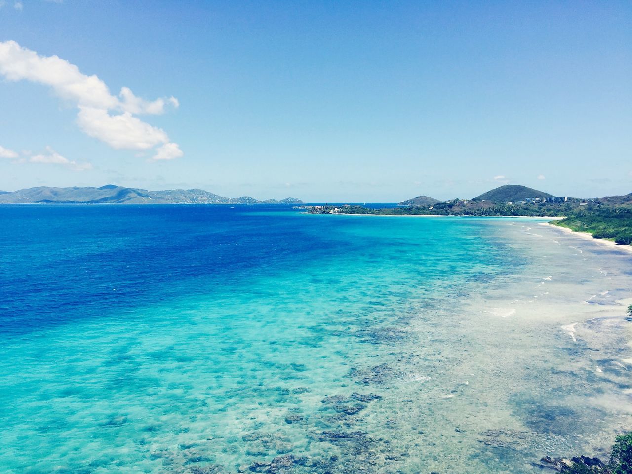 water, blue, sea, tranquil scene, scenics, tranquility, beauty in nature, mountain, nature, sky, copy space, waterfront, clear sky, idyllic, beach, day, coastline, rippled, mountain range, outdoors