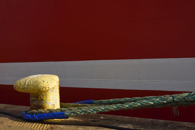 Close-up of rope on table against wall