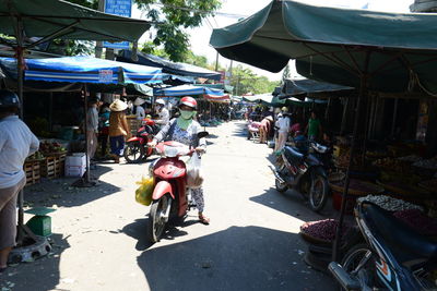 People riding motorcycle on street in city