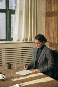 Young man sitting on table