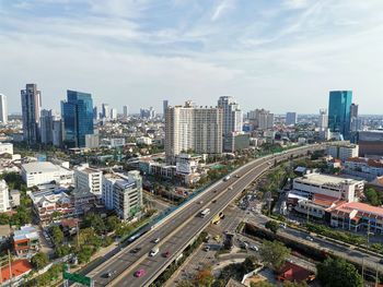 High angle view of street amidst buildings in city against sky