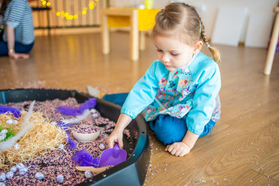 Portrait of cute boy playing with food at home