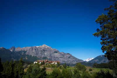 Scenic view of mountains against clear blue sky