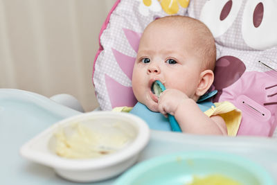 Portrait of cute baby girl eating food