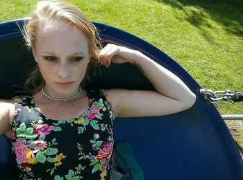 Portrait of a young woman sitting on ground