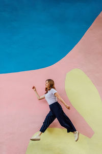 Full length of woman exercising at beach