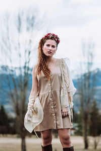 Portrait of beautiful woman standing against blurred background