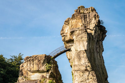 Low angle view of rock formation against sky