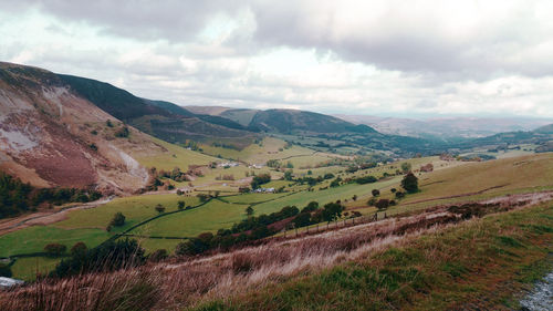 Scenic view of field and mountains against sky