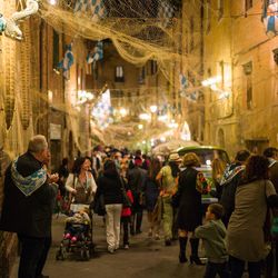 People on street in city at night during festival