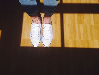 Low section of woman standing on tiled floor