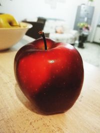 Close-up of apple on table at home