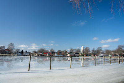 Scenic view of snow covered landscape against blue sky