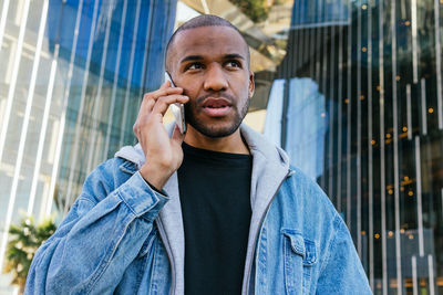 Portrait of young man standing in city