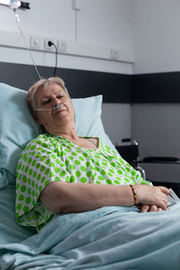 High angle view of woman lying on bed at home