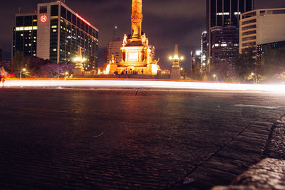 Illuminated city street and buildings at night