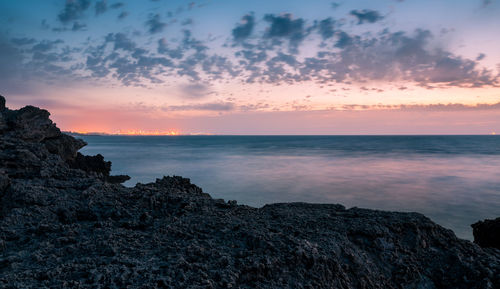 Scenic view of sea against sky at sunset