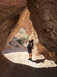 Full length of man standing by rock