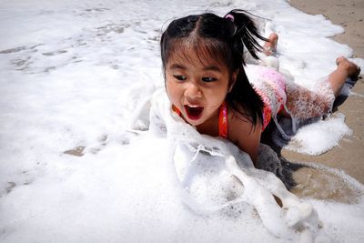 High angle portrait of cute girl in water