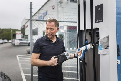 Man charging electric car