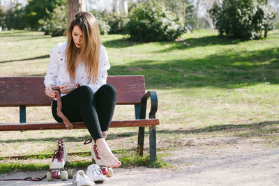 Young blonde woman prepares to skate