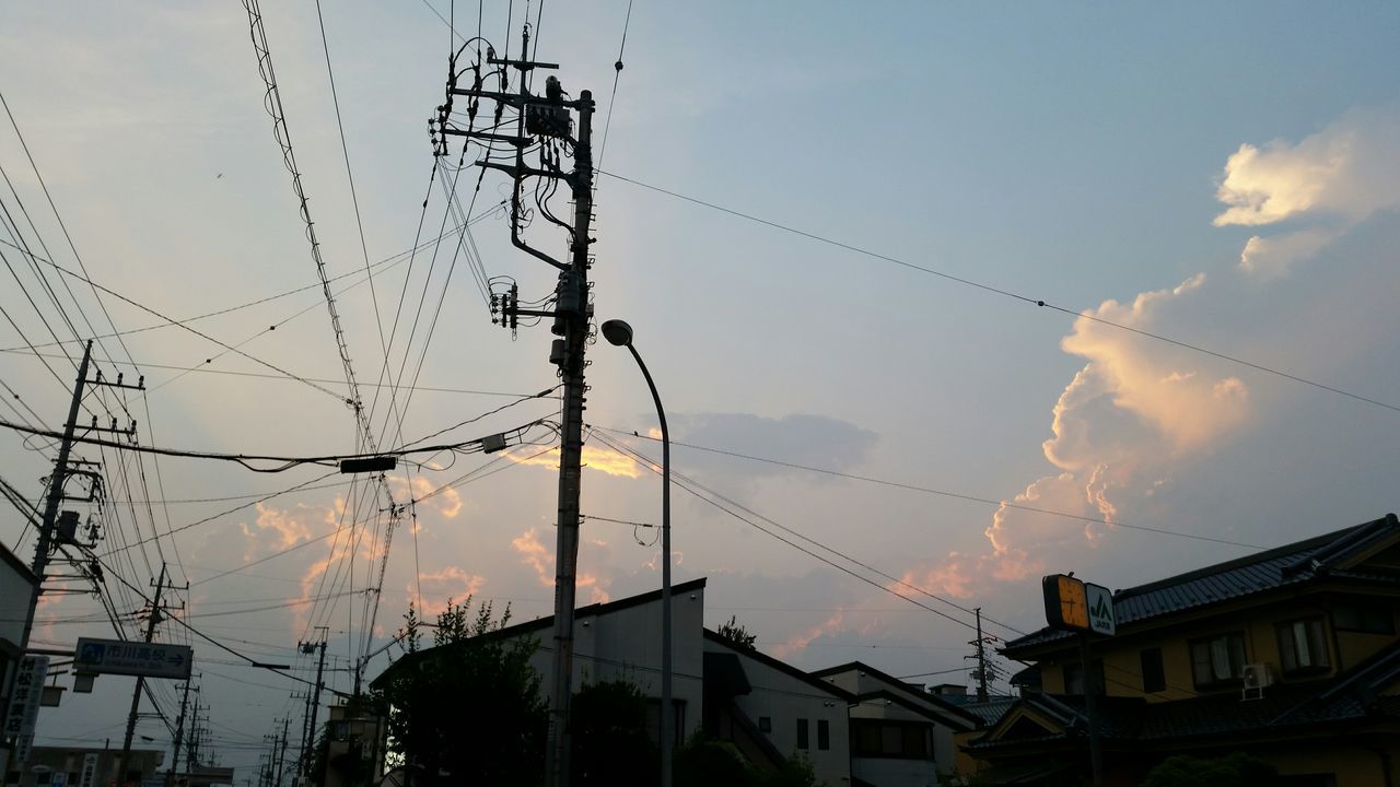 low angle view, sky, power line, building exterior, architecture, built structure, silhouette, electricity pylon, cable, electricity, connection, cloud - sky, power supply, cloudy, sunset, dusk, cloud, technology, street light, fuel and power generation