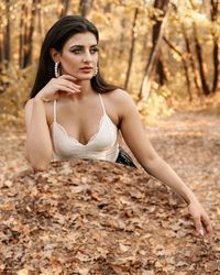 Beautiful woman sitting in forest with mirror