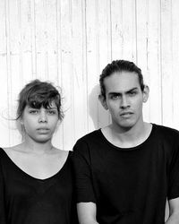 Portrait of boy standing against wall