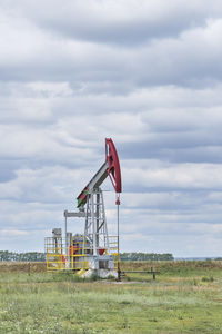 Low angle view of windmill against sky