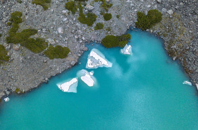 High angle view of rocks on sea shore