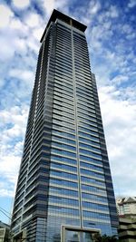 Low angle view of building against cloudy sky