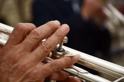 Cropped image of hand playing bass instrument