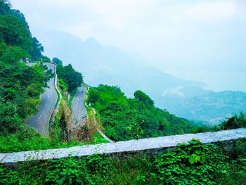 Scenic view of land and mountains against sky