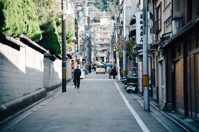 People walking on road in city