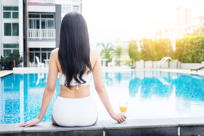 Rear view of woman in swimming pool