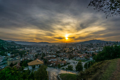 High angle shot of townscape against sky at sunset