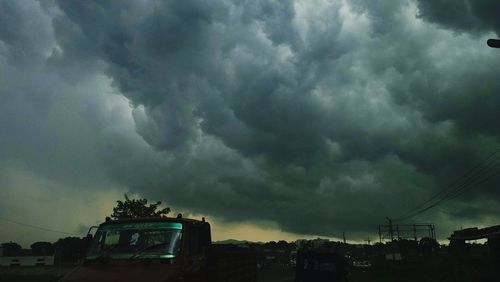 Low angle view of storm clouds over city